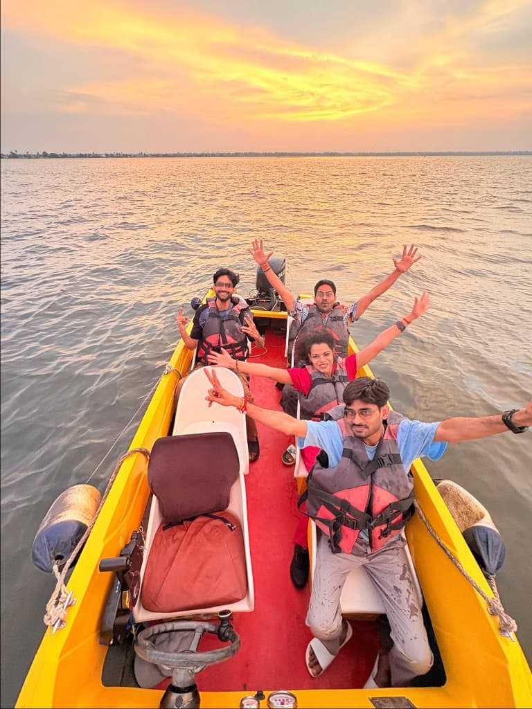 Happy riders on a speed boat at sunset, Punnamada Lake Alleppey Kerala